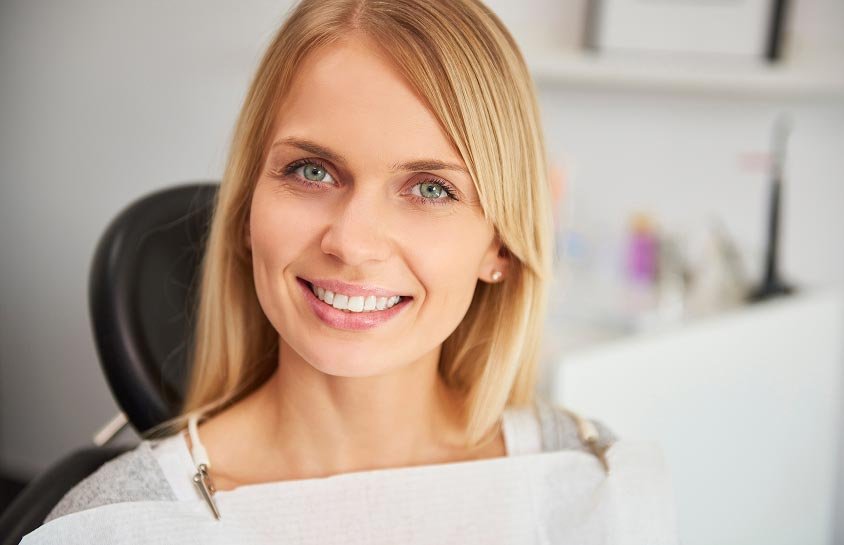 Smiling patient seated in a dental chair